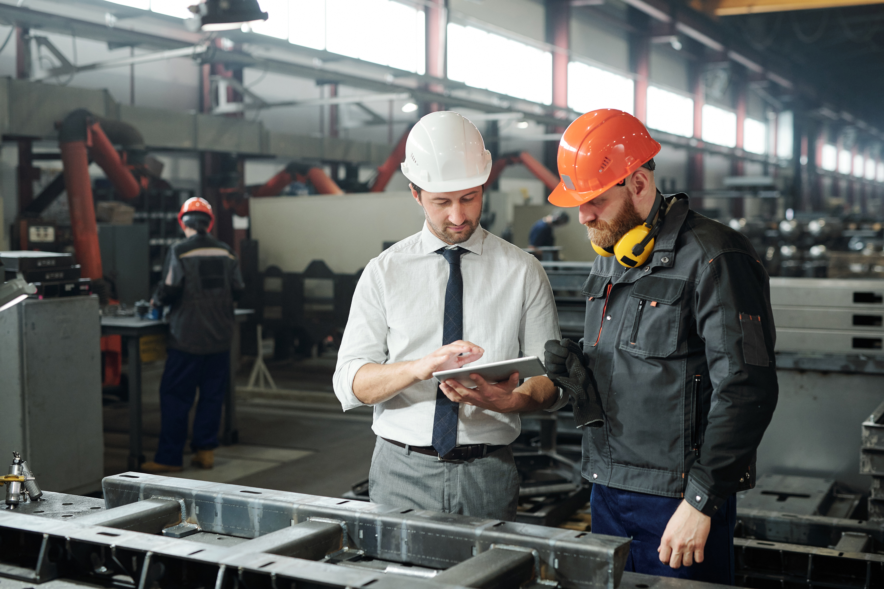 Business owner reviewing factory floor safety with a Loss Control Specialist.