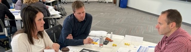 Photo of employees working together at a training session.