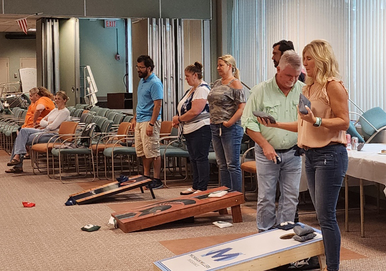 Employees playing a fun match of bean bags.