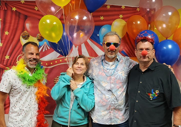 Four employees taking a fun group photo