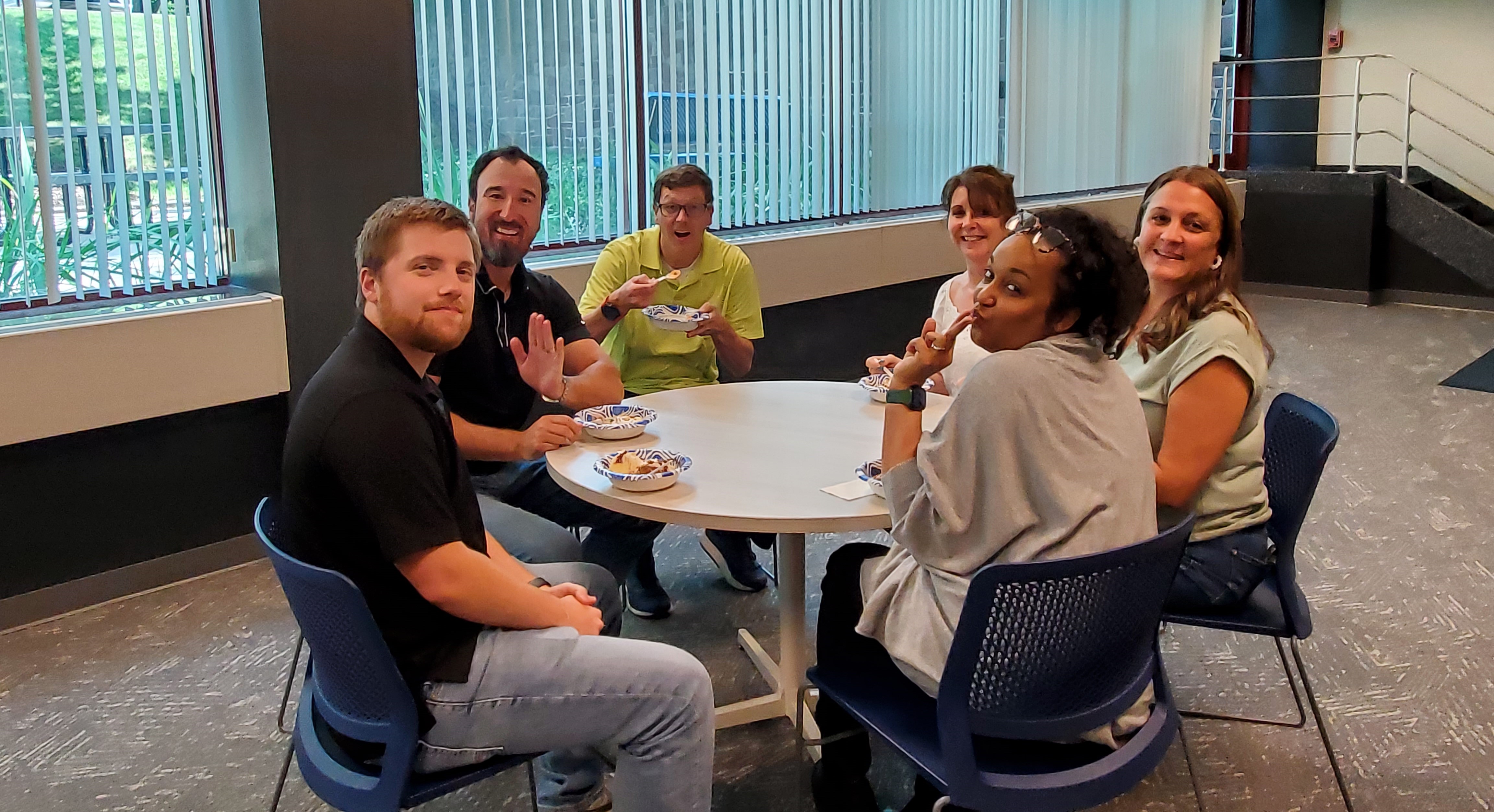 Claims Team sitting around at a circular table. 